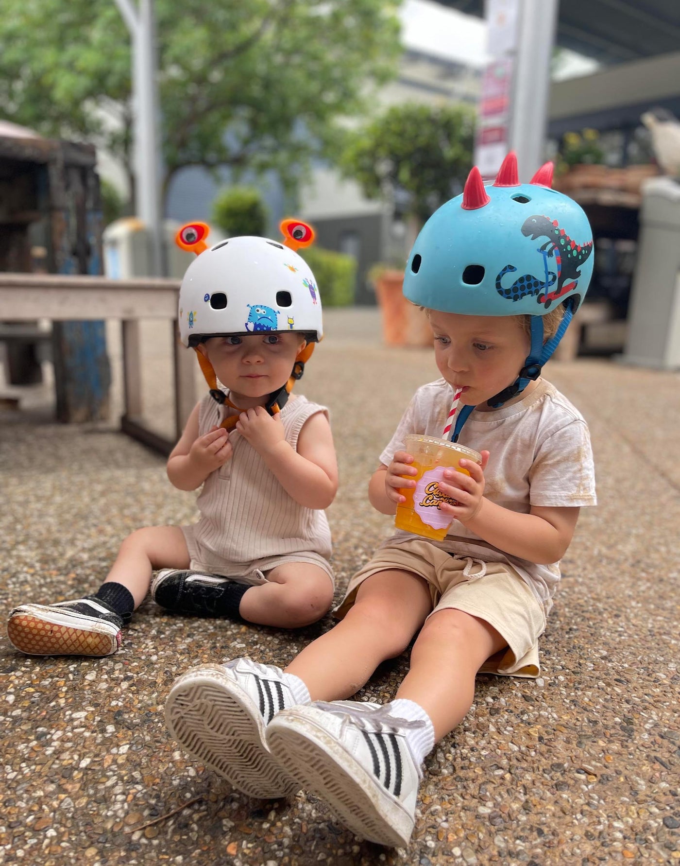 little boys wearing a monster and dinosaur 3d helmet