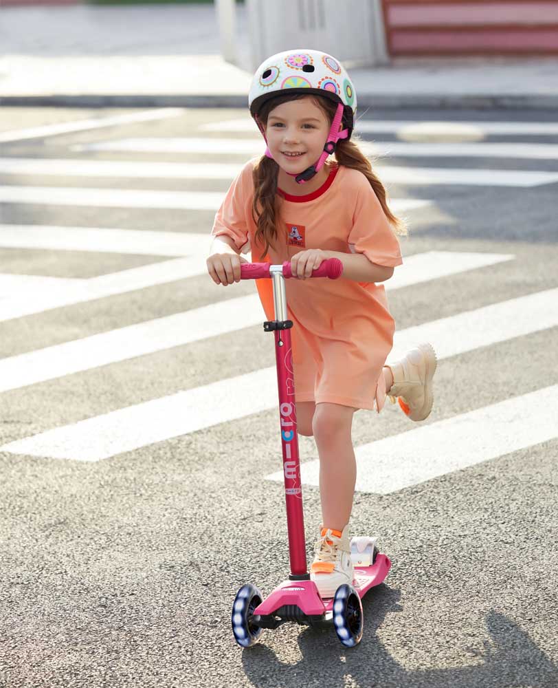 school kid on her light up 3 wheel kids scooter