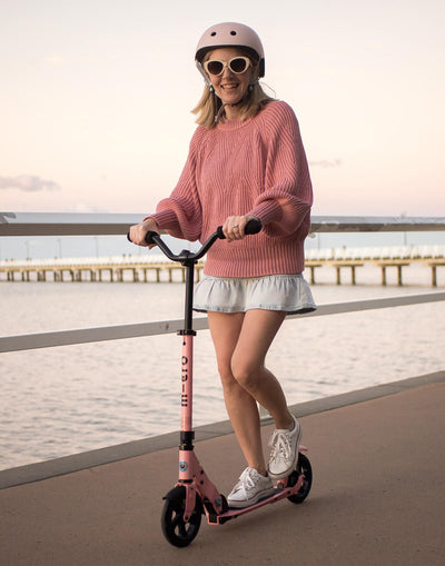 mum riding her neon rose pink 2 wheel adult scooter