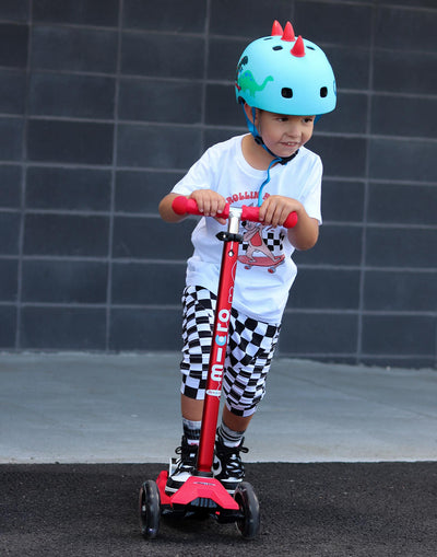 school aged kid riding maxi 3 wheel scooter with light up wheels