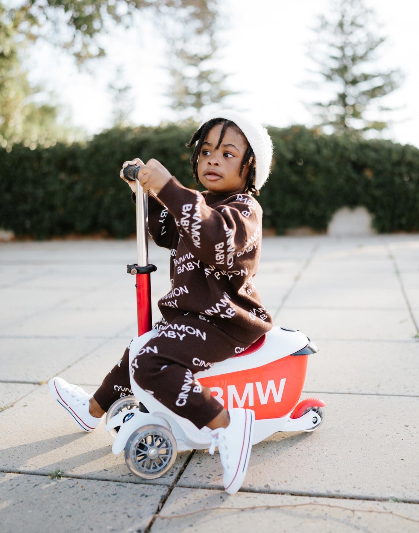 toddler sitting on the micro ride on mini2go scooter