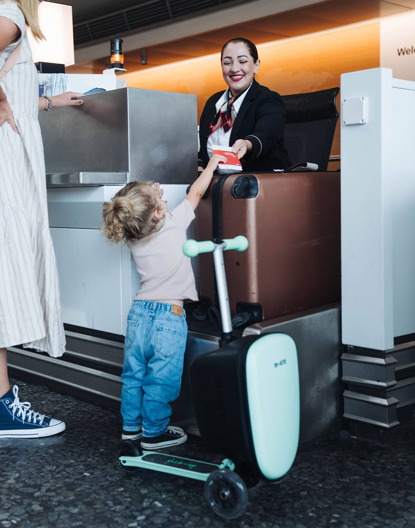 toddler with her luggage junior scooter at the airport