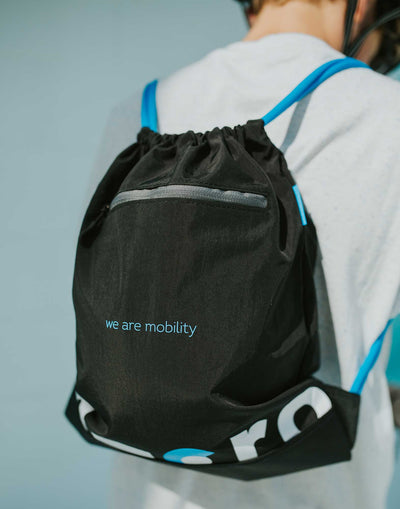 teen wearing black and blue micro branded gym bag
