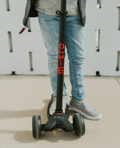 close up of boy on a maxi deluxe pro kids scooter