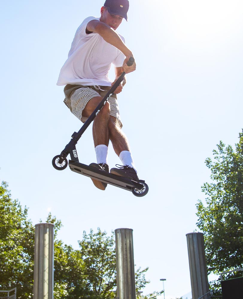 boy doing tricks on his stunt scooter