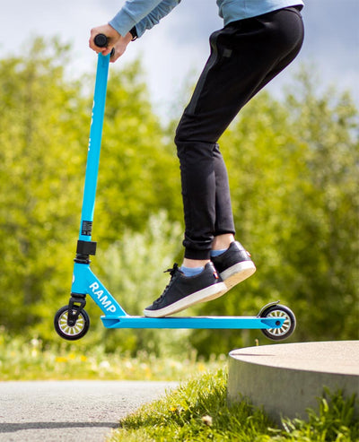 doing jumps on cyan stunt scooter
