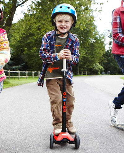 boy on maxi micro interchangeable scooter red