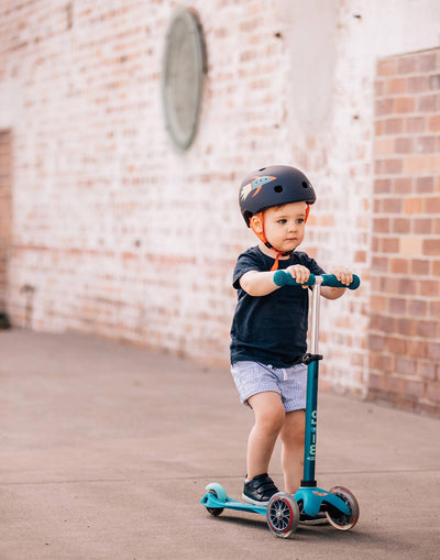 toddler riding on their aqua mini deluxe scooter