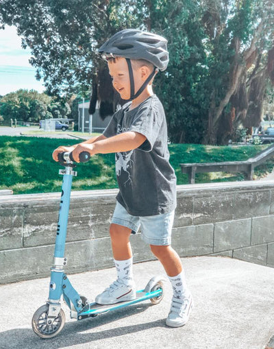 boy riding his light blue 2 wheeler kids sprite scooter