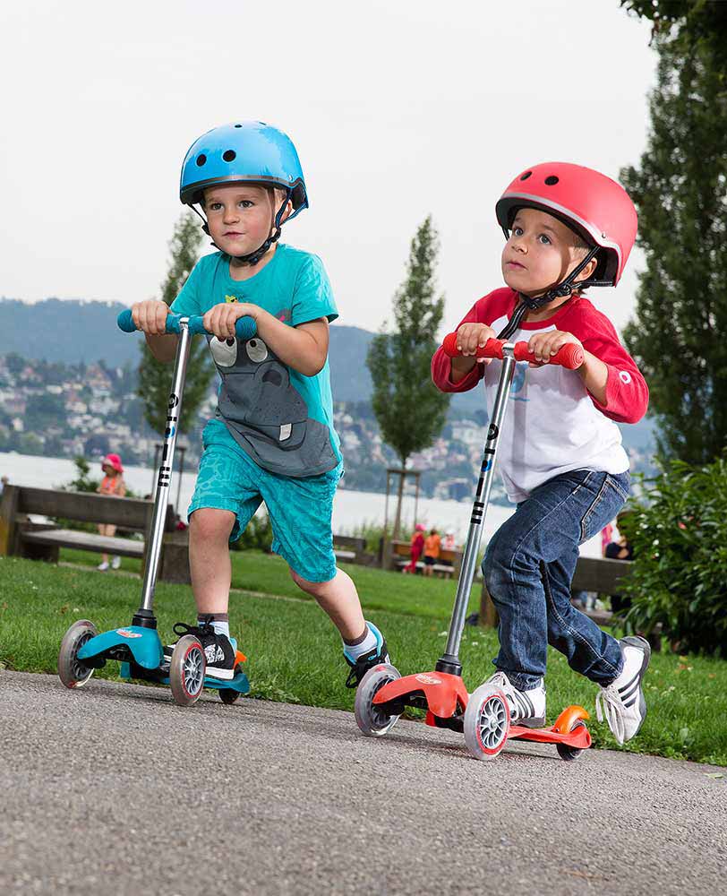 boys on their mini classic 3 wheel scooters