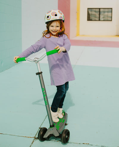girl on a green maxi deluxe pro kids scooter