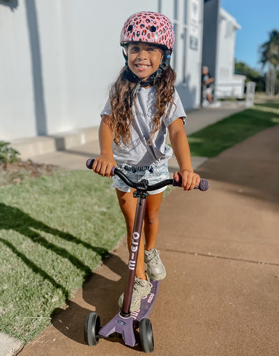 kid on their deep purple maxi deluxe pro scooter