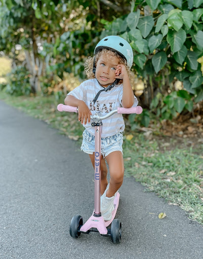 kid on her rose pink maxi deluxe pro scooter