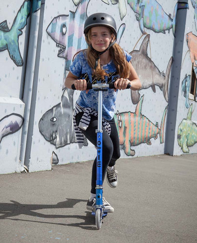 teen on their blue sprite 2 wheel kids scooter