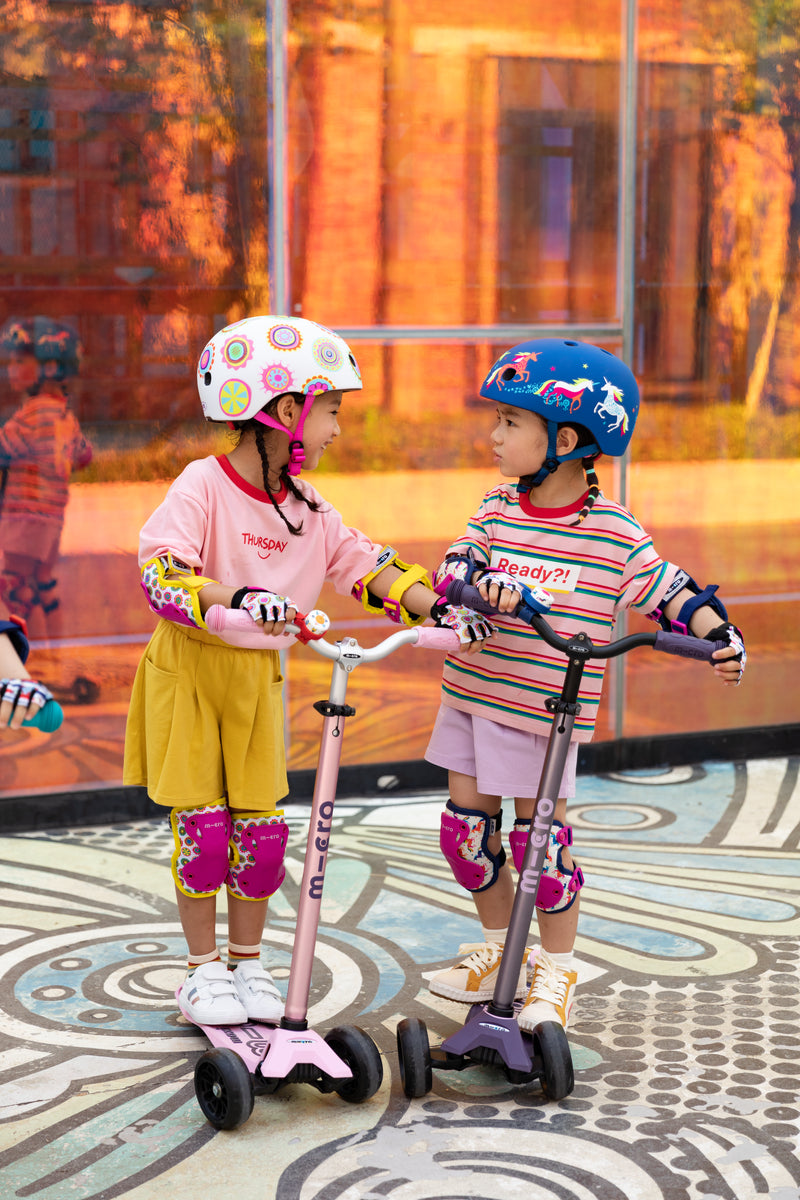 kids on maxi deluxe pro scooter with patterned bells