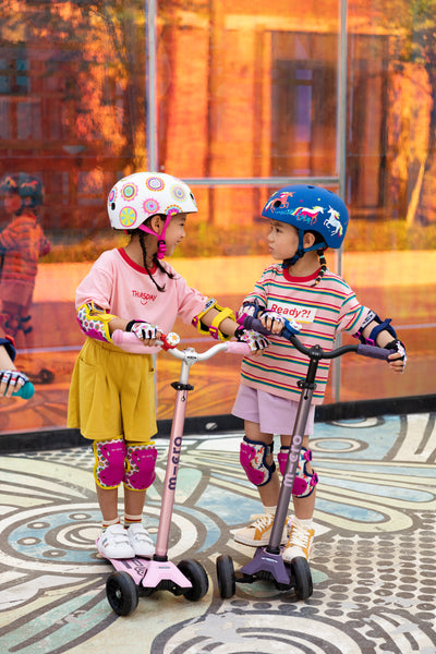 kids on maxi deluxe pro scooter with patterned bells