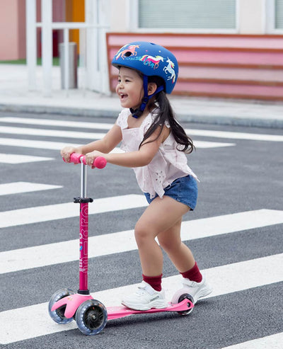 little girl on her awesome led pink mini deluxe scooter