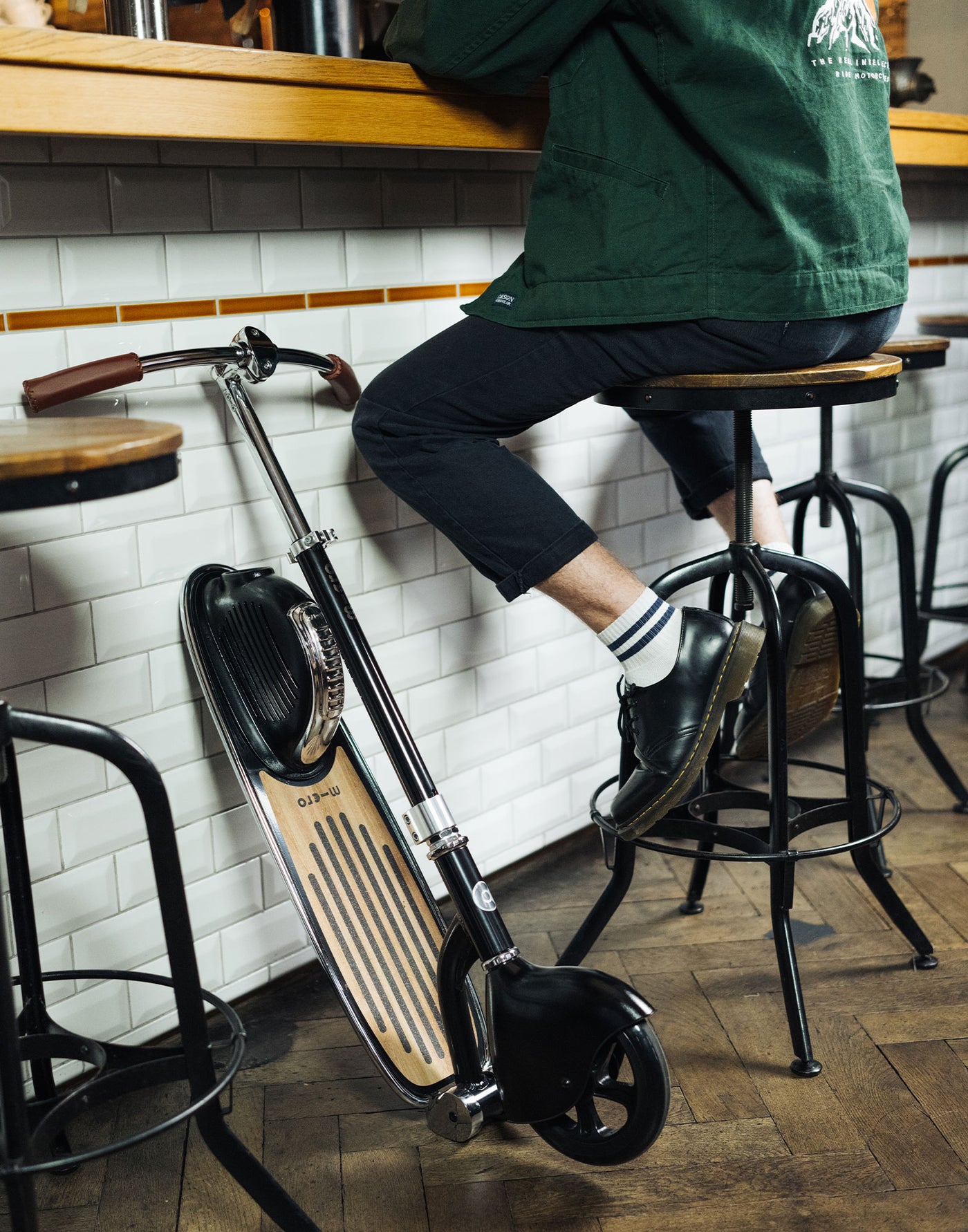 adult at a bar leaner with retro scooter