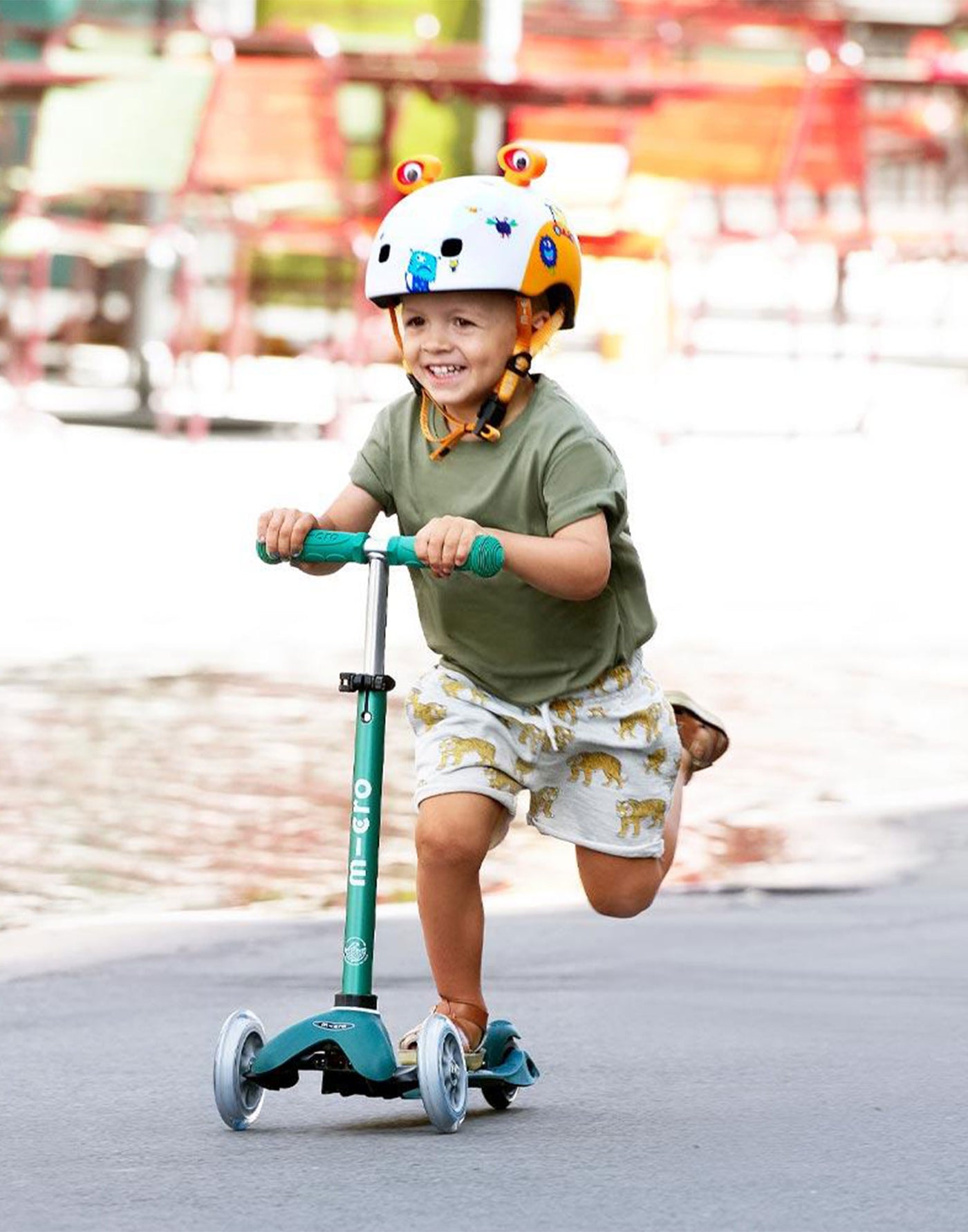 preschooler on their deep green eco mini deluxe scooter