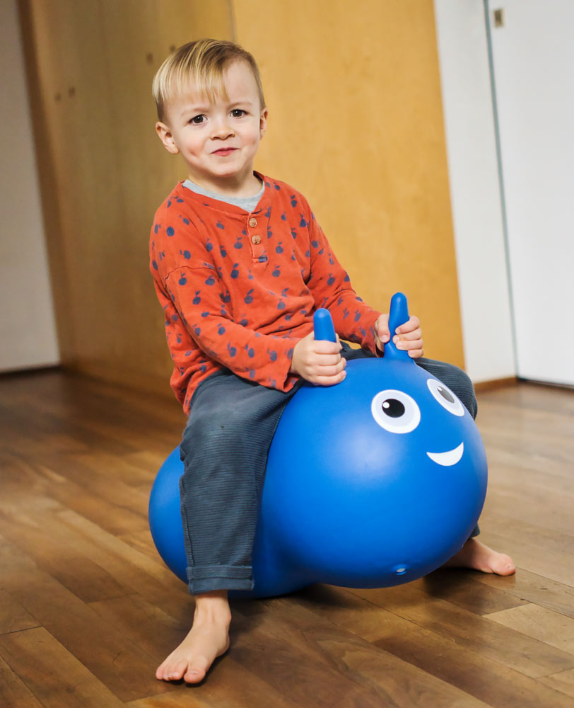 toddler bouncing on their blue air hopper with removable wheel plate